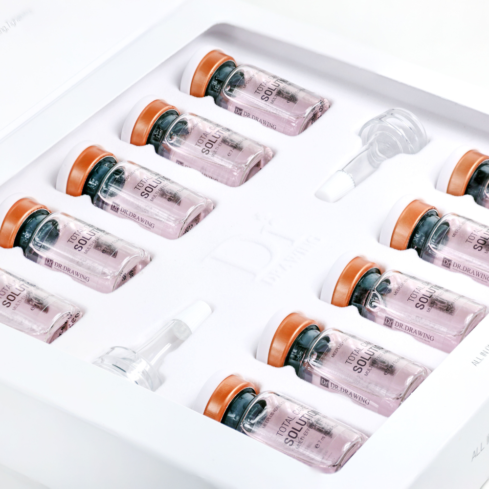 
                  
                    Multiple vials with orange caps on a white tray
                  
                